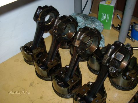 1979 Ford F-150 - Engine components are laid out on a workbench, possibly for repair or inspection.