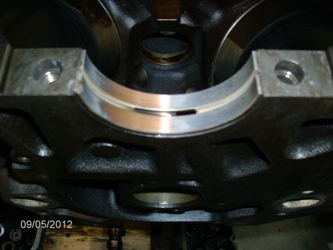 1979 Ford F-150 - Close-up view of an engine block's crankshaft bearing surfaces, showing wear.