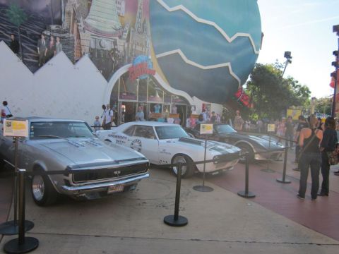 1991 Ford LTD Crown Victoria - Three classic cars are displayed outside a Planet Hollywood location.