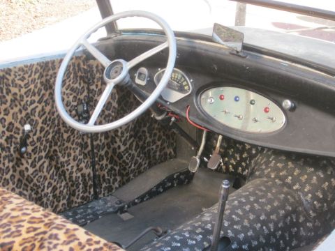 1991 Ford LTD Crown Victoria - The interior of this custom vehicle features unique leopard print upholstery and a classic dashboard with multiple toggle switches.