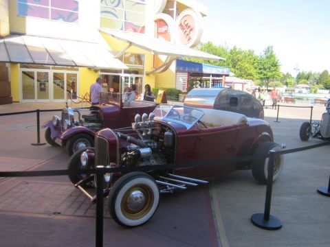 1991 Ford LTD Crown Victoria - A maroon hot rod is parked in front of Cafe Mickey.