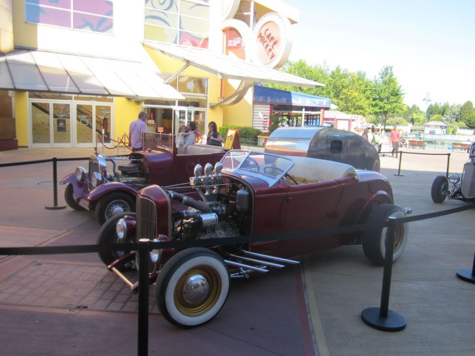 Maroon hot rod with exposed engine and whitewall tires