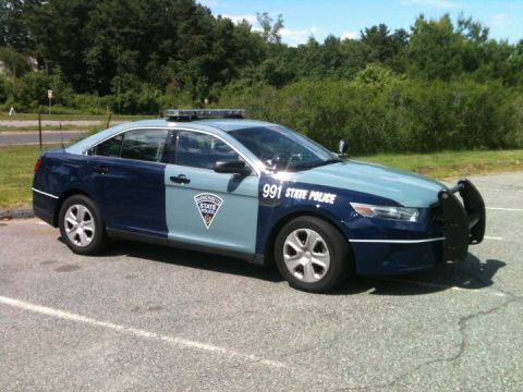 2004 Ford Crown Victoria - A Massachusetts State Police car, marked with "991 STATE POLICE", is parked in a lot.