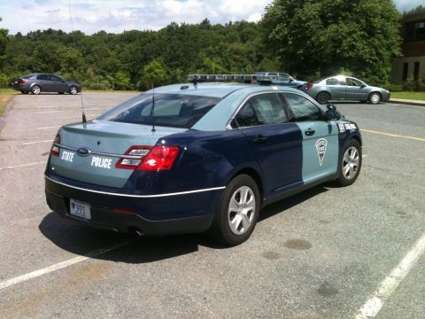 2004 Ford Crown Victoria - Ford Police Interceptor Utility with "STATE POLICE" markings on the rear.