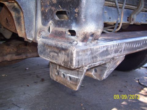1990 Ford Bronco - Close-up of a modified vehicle frame with visible welding and mounting points.