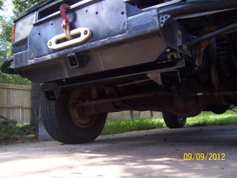 1990 Ford Bronco - Custom rear bumper with a large tow hook and hitch receiver is visible.