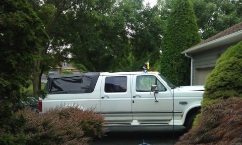 1994 Ford C-350 (Centurion Conversions) - This extended cab truck features a black soft tonneau cover over the bed and appears to be a 1994 Ford C-350 Centurion Conversions model.