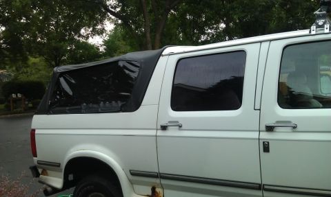 1994 Ford C-350 (Centurion Conversions) - White van with a black soft top, showing rust on the lower body panels and a Supermotors.net watermark.
