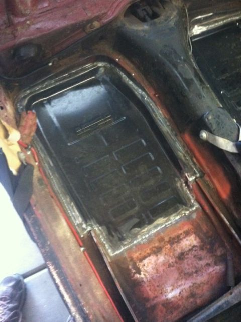 1970 Volkswagen Beetle - The floor pan of a car shows signs of rust repair and modification.