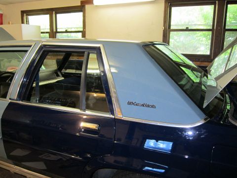 1991 Ford LTD Crown Victoria - Side view of a 1990 Ford Crown Victoria LTD, showing its two-tone paint scheme and vinyl roof.