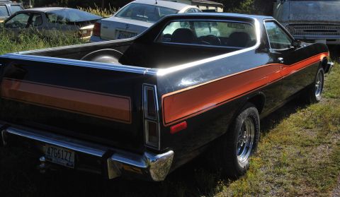 1975 Ford Ranchero - This 1975 Ford Ranchero features a distinctive orange stripe along its side and bed.