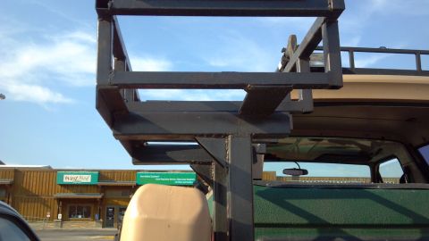 1986 Ford Bronco - Version 3 of my cooler rack. It sits above the jerry cans. Removable, but even in place it doesn't block my rear view, unless fully loaded.