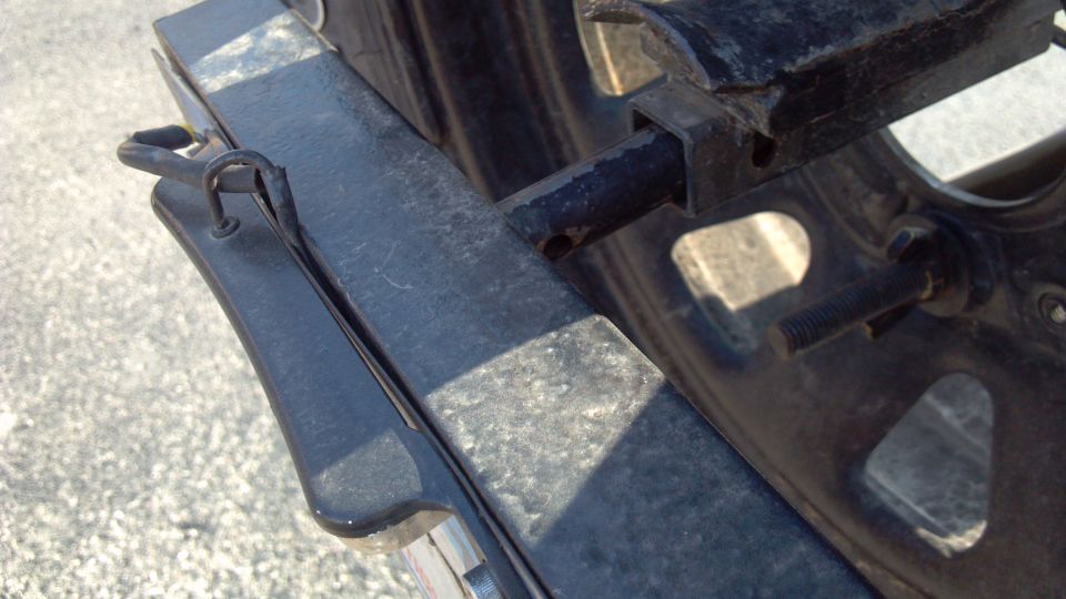 With the locking pin removed, the light is un-plugged, and the whole bracket slides out.