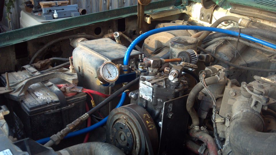 York 210 R air conditioning compressor from a '69 IH Travelall. I removed the smog pump, leaving the bracket in place.  One air line runs to the front quick disconnect, the other goes back to a 2 1/2 gallon air tank.  You can see my pressure gauge, the pressure relief, tank supply, pressure switch, and  supply line from the compressor