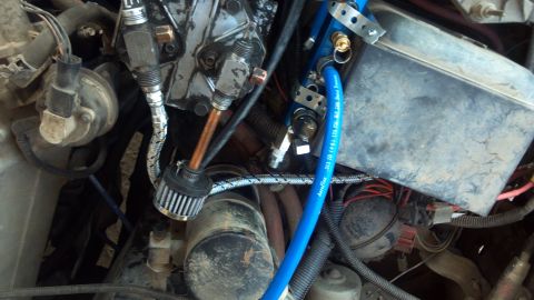 1986 Ford Bronco - Looking down on top of the setup. The steel braided line is the outlet from the compressor, and will screw into the check valve of the mani…