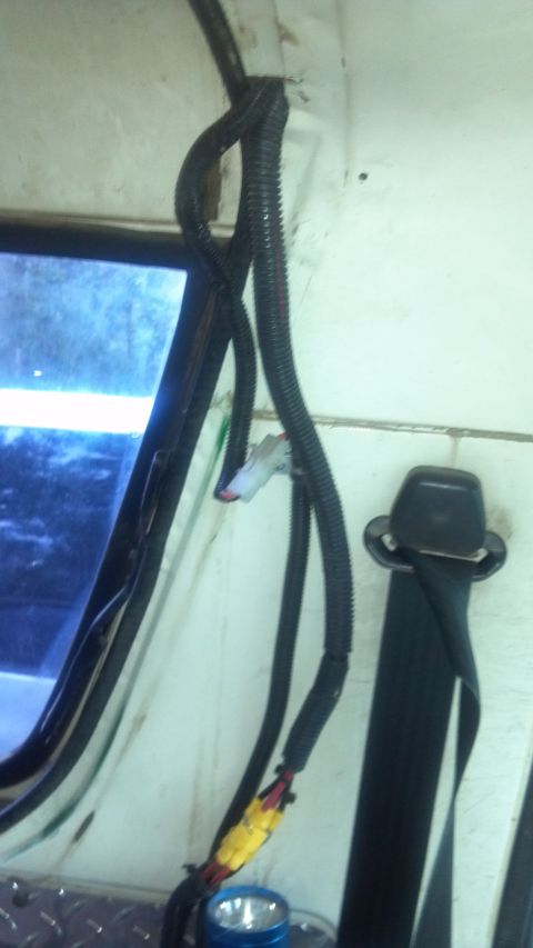 1986 Ford Bronco - There's a small slot in the lip of the cab area there the top seals. I widened it a little bit so I can tuck these two looms through there.…