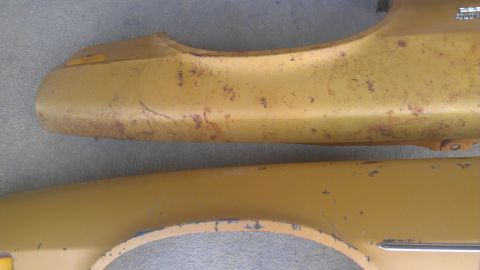 1973 Chevrolet Camaro - Two yellow fender parts show significant rust and paint damage.