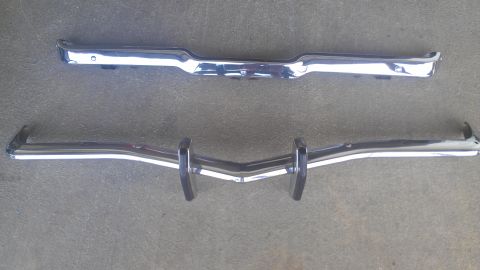 1973 Chevrolet Camaro - Two chrome bumpers displayed on a gray surface. The registry claims they are from a 1973 Chevrolet Camaro, but this is unconfirmed.