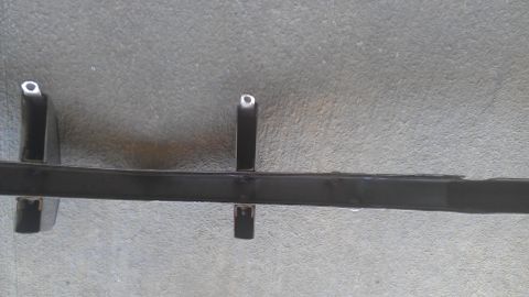 1973 Chevrolet Camaro - A metal car component is shown resting on a textured concrete floor, with a website logo visible.