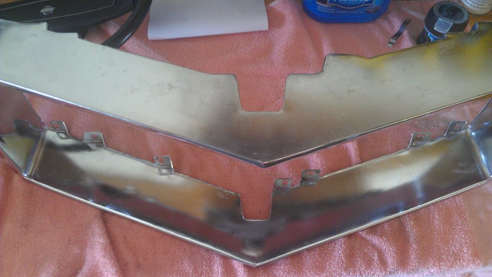 Chrome grille part on red cloth
