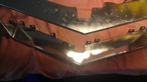 1973 Chevrolet Camaro - Chrome trim pieces with mounting tabs are shown on a towel.