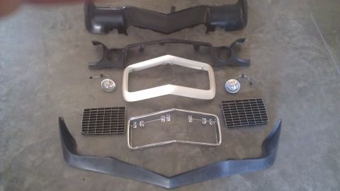 1973 Chevrolet Camaro - Various automotive parts are arranged on a flat surface, ready for assembly or display.