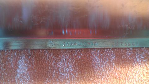 1973 Chevrolet Camaro - A metal component displays stamped identification numbers, suggesting it's a manufactured part.