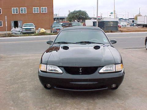 1995 Ford Mustang - This black Ford Mustang features a distinctive grille and hood scoops, typical of the SN95 generation.