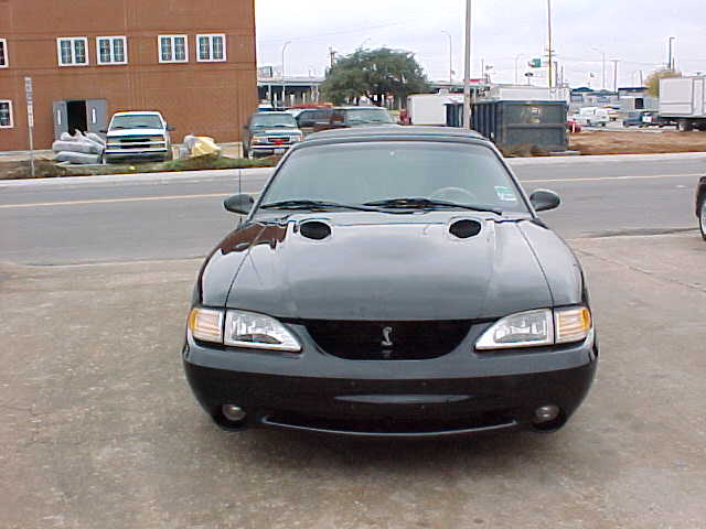 Black Ford Mustang SVT Cobra convertible front view with hood scoops