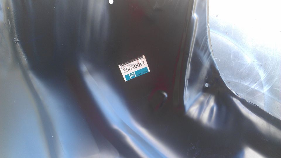 Sheet metal part with GM sticker showing part number 14005962