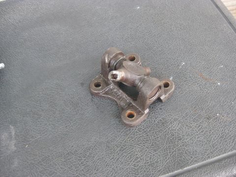 1994 Ford Bronco - A metal universal joint part is shown against a dark, textured background.