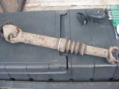 1994 Ford Bronco - A driveshaft component, likely from a truck or SUV, is shown laid out on a textured surface.