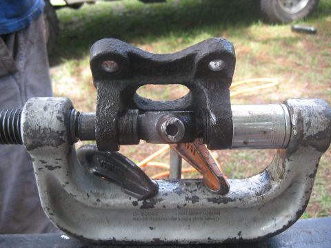 1994 Ford Bronco - Universal joint yoke held in a vise, part of a vehicle's drivetrain.