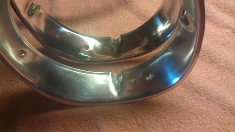 1973 Chevrolet Camaro - Close-up of two chrome trim rings, possibly for a vintage car, resting on a pink towel.
