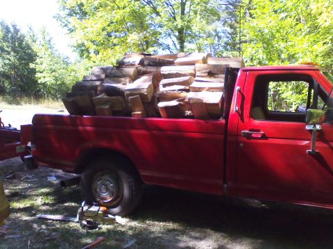 1987 Ford F-250 - Red 1987 Ford F-250 pickup truck loaded with firewood in the bed.