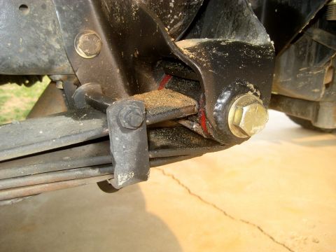1996 Ford Bronco - This image shows a close-up view of a vehicle's rear suspension leaf spring and its mounting hardware.