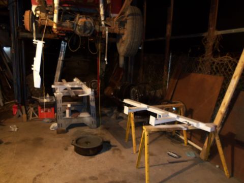 1989 Ford Bronco - A vehicle is undergoing maintenance, with its rear end elevated and components disassembled.