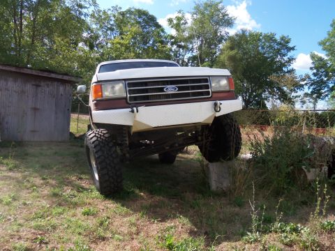 1989 Ford Bronco - This modified Ford truck features a custom front bumper and aggressive off-road tires, suggesting it's built for terrain.