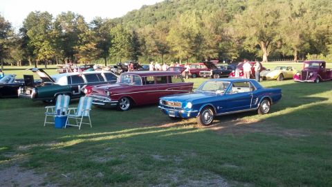 2007 Ford Mustang - A gathering of vintage automobiles displayed outdoors on a sunny day.