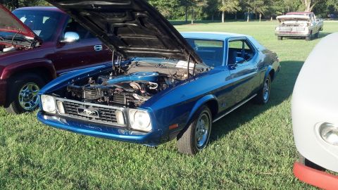 2007 Ford Mustang - A blue 1971 Ford Mustang coupe is displayed with its hood open at a car show, alongside other vehicles.