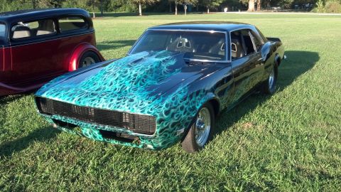 2007 Ford Mustang - Customized classic muscle car with flame paint and aftermarket hood scoop, parked next to another vehicle.