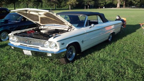 2007 Ford Mustang - A white 1963 Ford Galaxie convertible is displayed with its hood up at an outdoor event.