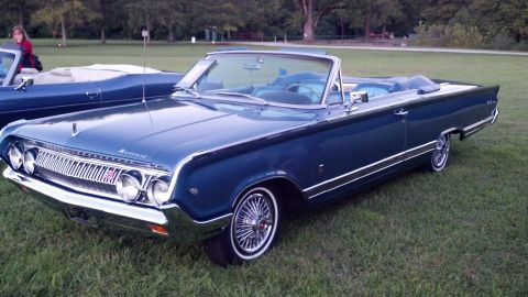 2007 Ford Mustang - A blue 1964 Mercury convertible is parked on a grassy field next to another blue convertible.