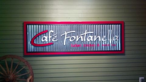 2007 Ford Mustang - Sign for Cafe Fontanella, an Italian Kitchen and Wine Bar, mounted on a green paneled wall.