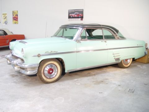 1954 Mercury Monterey - This 1954 Mercury Monterey Sun Valley coupe is light green with a black roof, seen indoors.