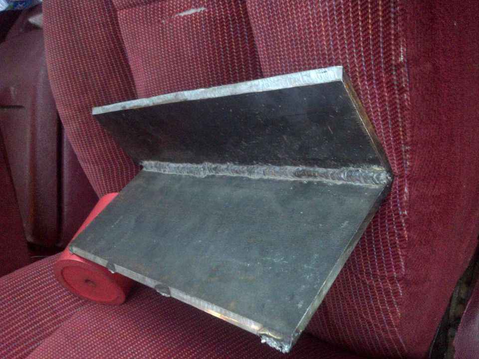 welded metal bracket on red patterned car seat