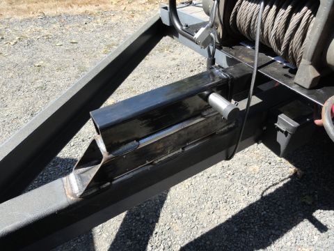 1966 International Scout 800 - Close-up view of a trailer's winch and structural frame components.