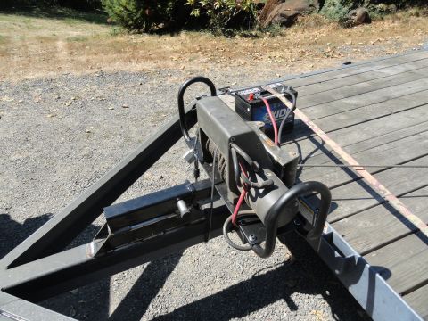 1966 International Scout 800 - A winch and battery are mounted on a trailer, ready for use.