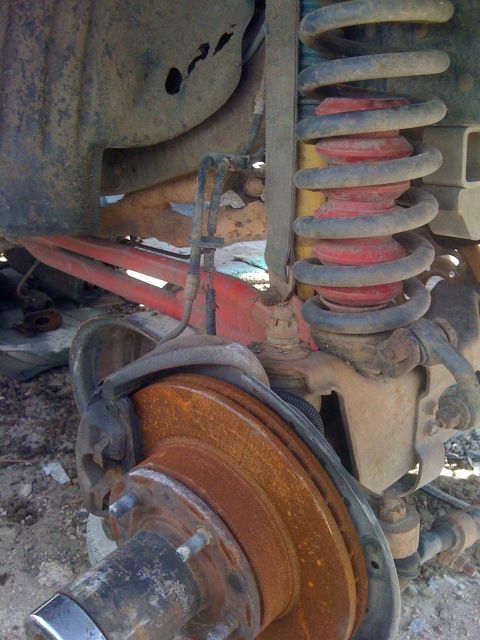 1979 Ford Bronco - This image shows the detailed suspension and braking system of a vehicle, with visible rust on the components.