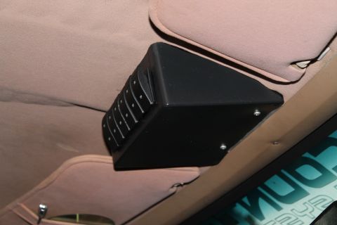 1990 Ford Bronco - A black overhead console with multiple buttons is visible inside a vehicle's interior.